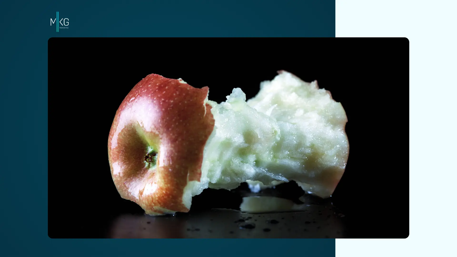 An apple that haas been mostly eaten against a black background